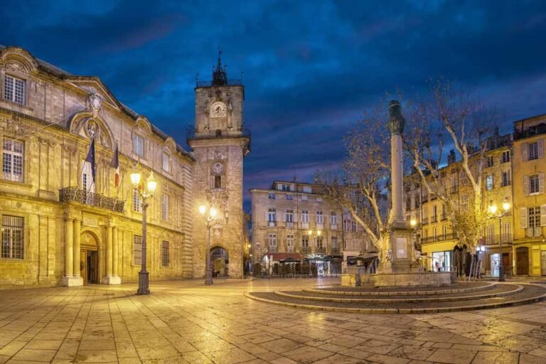 Town Hall square at dusk with City Hall (Hotel de Ville) building, clock tower and fountain in Aix-en-Provence, France