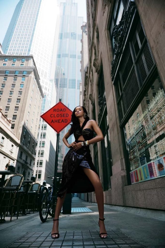 Lili Blanc Black Sequin Skirt; Nayades the Label Black Cutout Swimsuit; MANNATT GUPTA Black Embellished Wrap Bustier; Erickson Beamon Birdcage Earrings; Kat Maconie Black Esida Sandals shoes; Kate Spade, Armani Exchange, Skagen, and Guess watches.