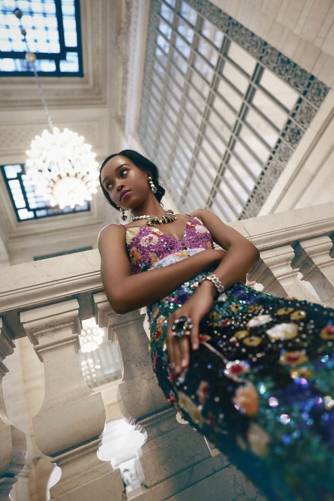 Karina Di Angeli Sequin Dress; Francesca Bellavita Pink Sandals; Erickson Beamon Alligator Necklace, Drop Earrings, Floral Ring; Kate Spade Watch.